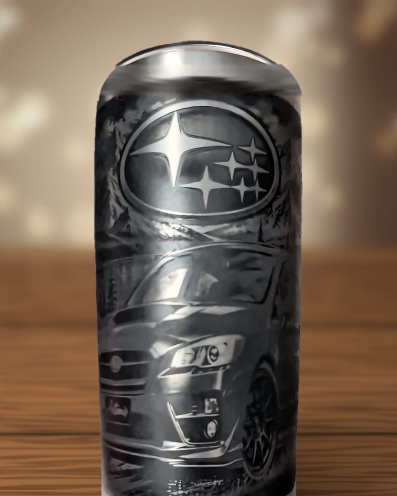 Black tumbler laser-engraved with the Subaru star logo above the front of a WRX sedan